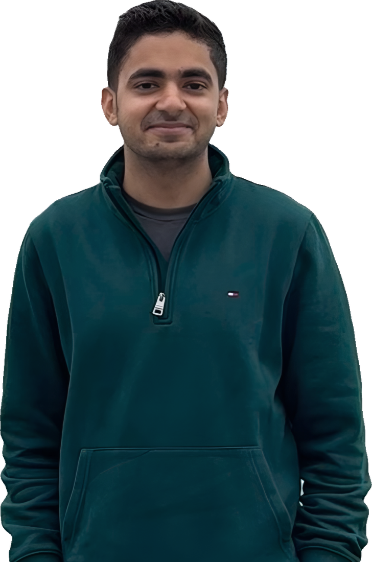 Ajay Sachdev, smiling, in a green quarter-zip